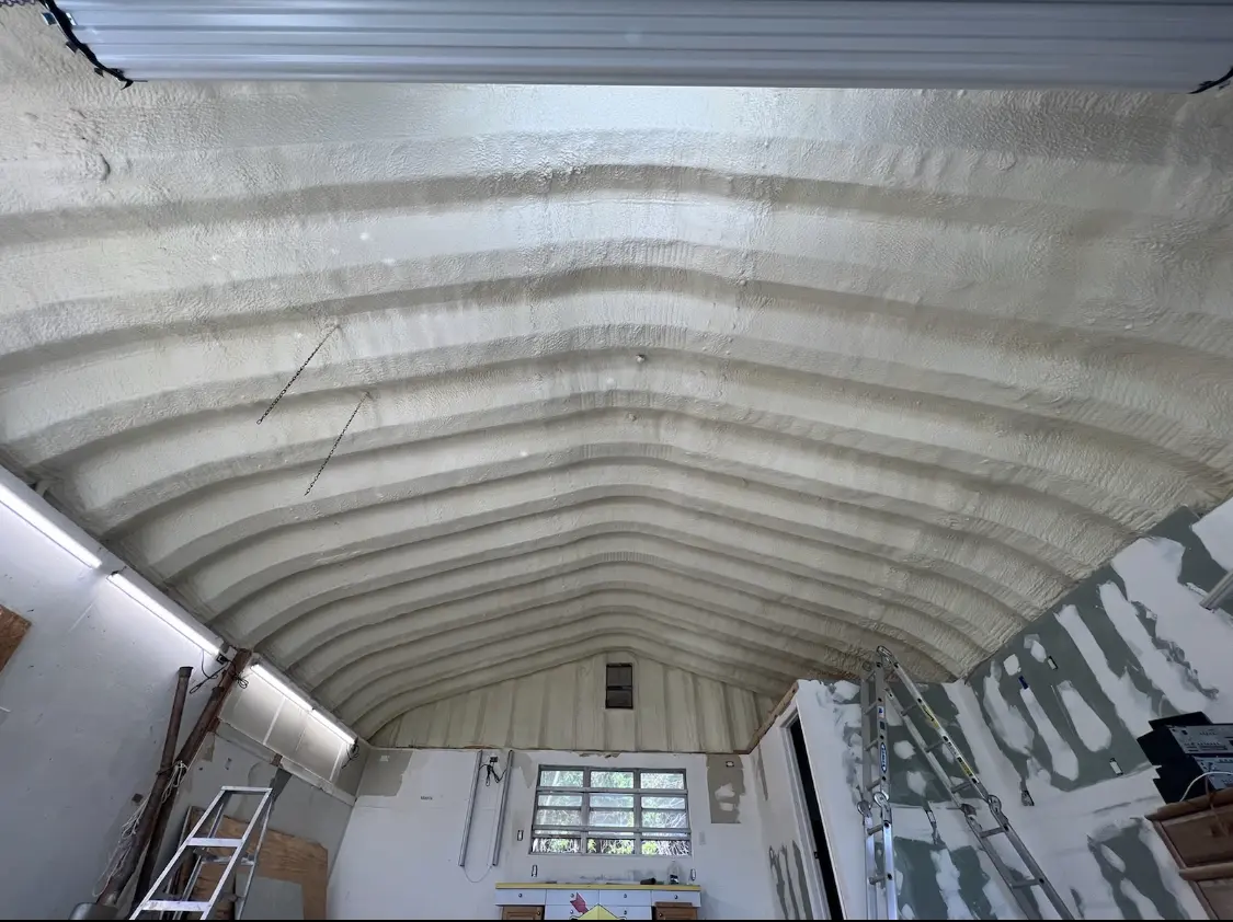 Spray polyurethane foam applied to the underside of a metal roof deck in Inkster
